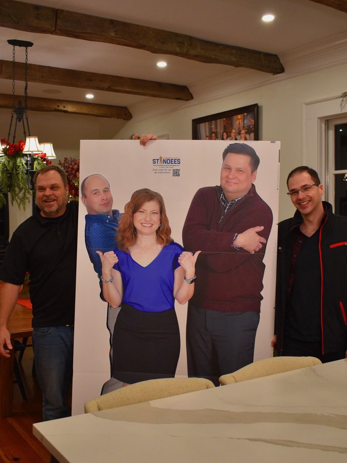 raxis teammates holding up a cardboard cutout of colleagues
