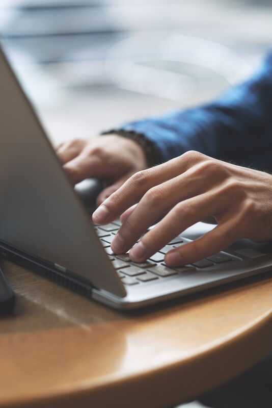 hands typing on computer keyboard