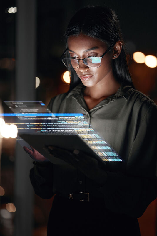 lady holding a tablet computer showing data